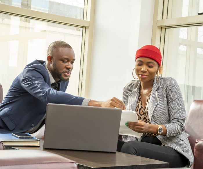 young-black-businessman-woman-going-through-some-paperwork-together (1)